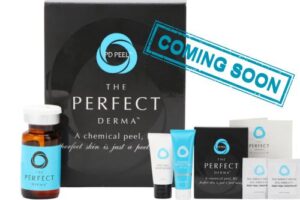 Image of skincare products labeled "The Perfect Derma." Includes a chemical peel bottle, various tubes, sachets, and a large box. A blue stamped text reads "COMING SOON.