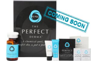 Image of a skincare product set including a box labeled "The Perfect Derma Peel," various cream tubes, vials, and informational cards. A blue "Coming Soon" stamp overlays the image.